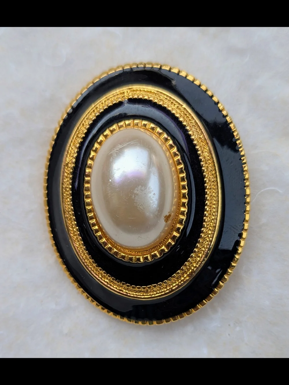 Black and Gold Oval Brooch with Central Pearl Accent